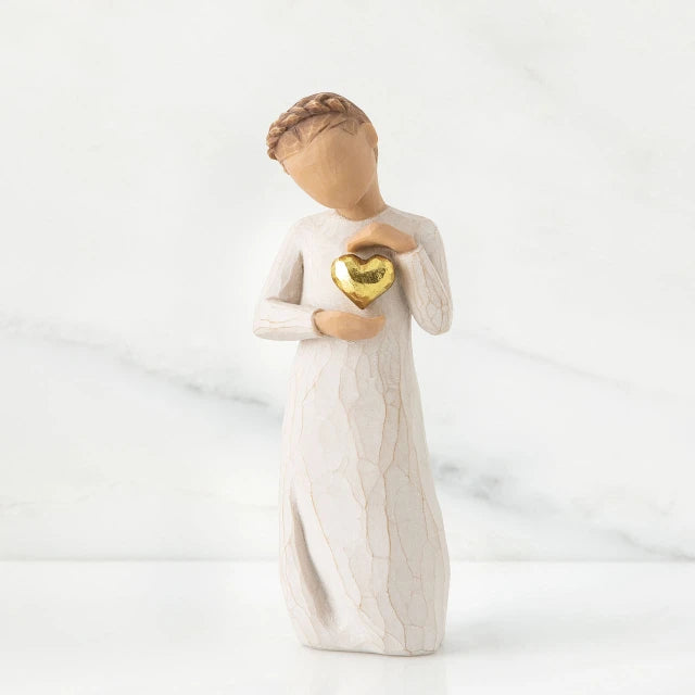 Willow Tree® Small girl figurine wearing white dress holding up gold heart pendant