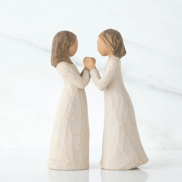 Willow Tree® Two brunette girl figurines in white dresses holding hands facing one another