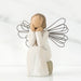 Willow Tree® Front view of angle with brown hair sitting on a stone with her hands cupping her cheeks