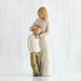 Willow Tree® Faceless woman figurine in white dress standing over faceless young boy in white shirt with brown pants