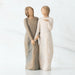 Willow Tree® Two faceless woman figurines standing facing forward holding hands - left one is wearing light brown dress, right one is wearing white dress