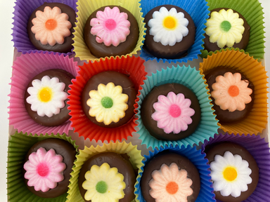 Chocolate candies with floral designs in colorful paper cups