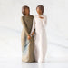 Willow Tree® Front view: Figure of two women with darker skin tones in different colored dresses, standing arm in arm