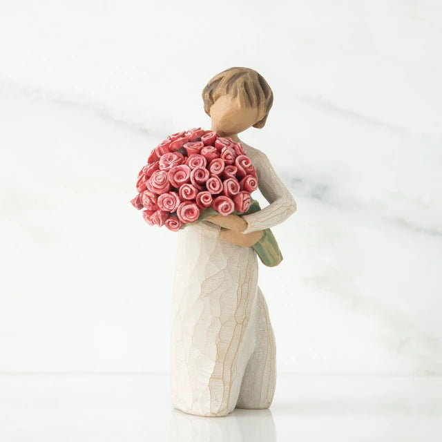 Willow Tree® Small faceless girl figurine in white dress holding large pink roses boquet