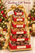 Bear Creek Candy Kitchen Christmas gift tower showing six open red-and-gold boxes containing chocolate truffles, sea-salt caramels, peanut brittle, pecan pralines, pecan turtles, and chocolate fudge.