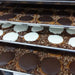 Bear Paws cooling on trays in the Bear Creek Candy Kitchen