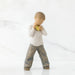 Willow Tree® Young boy faceless figurine in white shirt and blue jeans holding gold heart figurine standing up