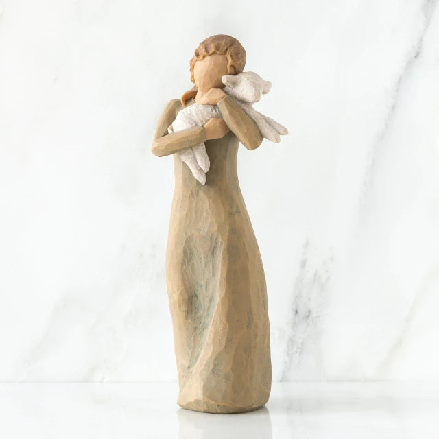 Willow Tree® Faceless woman figurine standing wearing light tan dress holding white lamb in her arms