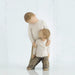 Willow Tree® Two small boy figurines wearing white shirts and brown pants -one is standing over holding the other