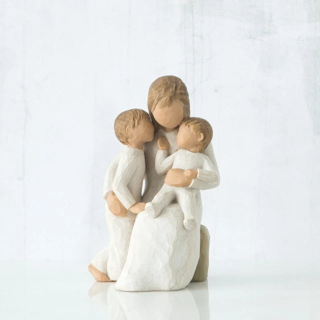 Willow Tree® Faceless mother figurine sitting down holding two faceless children figurines in her arms