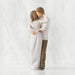 Willow Tree® Front view of couple, standing with arms around each other. Woman has darker skin and hair; man has lighter skin and hair.