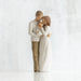 Willow Tree® Faceless woman and man figurine standing holding baby in their arms - all in white