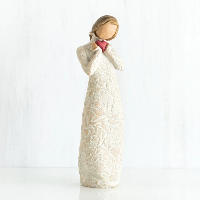 Willow Tree® Standing faceless woman figurine in white dress facing forward holding pink heart