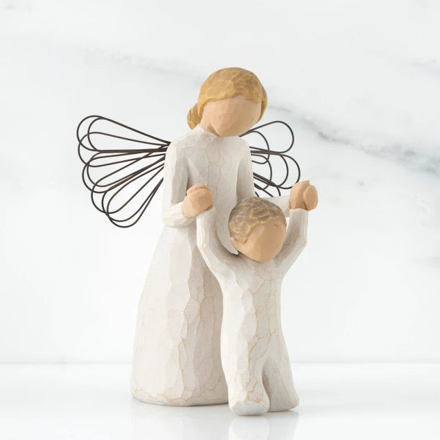 Willow Tree® Mother faceless figurine with blonde hair wearing white dress and has black wire wings - holding baby standing on its feet