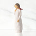Willow Tree® Front view of standing figure in cream dress with cardinal red bird perched on shoulder