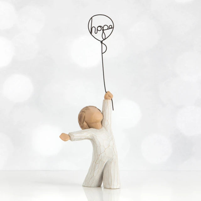 Willow Tree® Small child faceless figurine in white standing holding black wire 'hope' balloon up with one hand