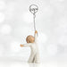 Willow Tree® Small child faceless figurine in white standing holding black wire 'hope' balloon up with one hand