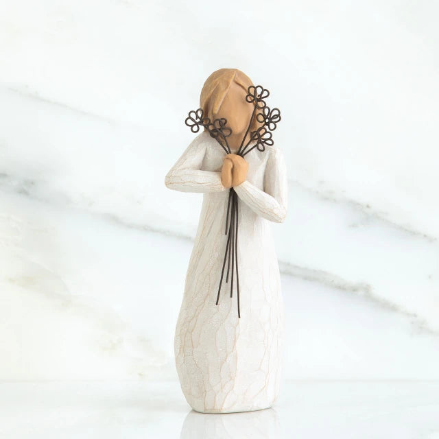 Willow Tree® Close view of blonde woman figurine in white dress holding black flower boquet
