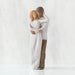 Willow Tree® Front view of couple, standing with arms around each other. Woman has lighter skin and hair; man has darker skin and hair.