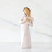 Willow Tree® Front view: Standing figure in cream dress with hands to heart in empathetic gesture