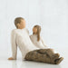 Willow Tree® Man figurine and daughter faceless figurines sitting looking at one another - wearing white shirts and brown pants