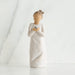 Willow Tree® Front view of woman with brown hair in a high ponytail leans forward as she holds a gray bird to her chest with both hands
