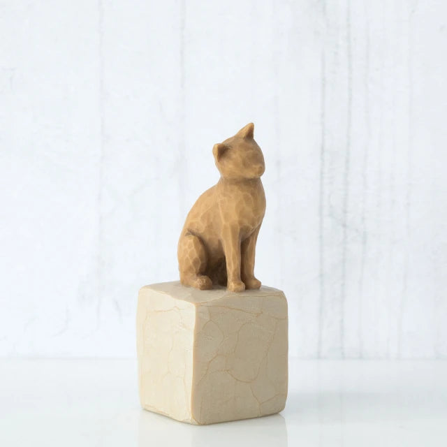 Willow Tree® Golden cat figurine sitting on white rock