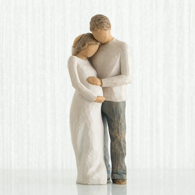 Willow Tree® Man and woman faceless figurines - woman is wearing white dress and man is wearing white shirt and blue jeans holding woman's stomach