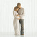 Willow Tree® Man and woman faceless figurines - woman is wearing white dress and man is wearing white shirt and blue jeans holding woman's stomach