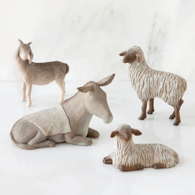 Willow Tree® Light grey donkey figurine laying down surrounded by three sheep standing figurines