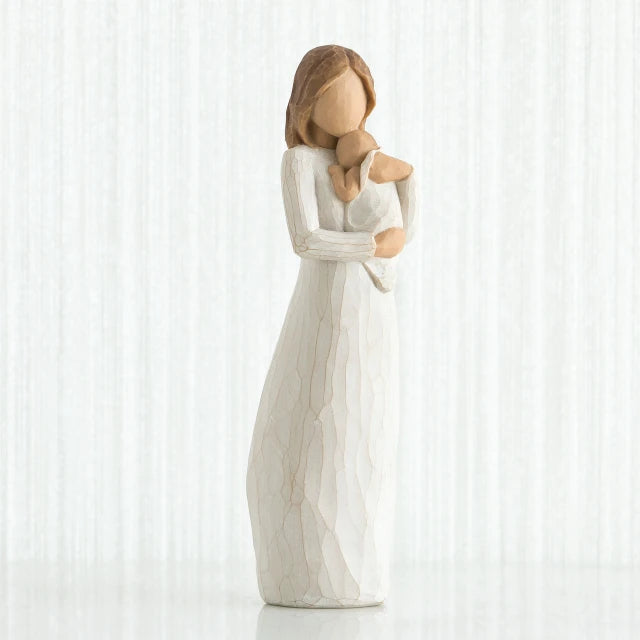 Willow Tree® Faceless mother figurine wearing white dress holding baby to her neck