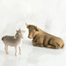 Willow Tree® Brown cow figurine laying next to white goat figurine standing up