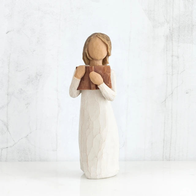 Willow Tree® Young faceless girl figurine standing up wearing white dress holding brown book to her face