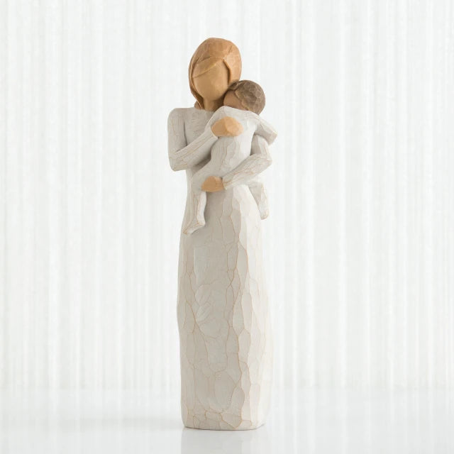 Willow Tree® Faceless woman figurine in white dress holding brown haired baby in white clothes