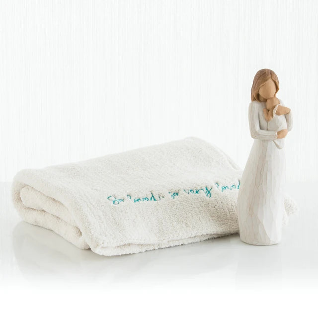 Willow Tree® Brown haired woman figurine wearing white holding baby - next to white towel
