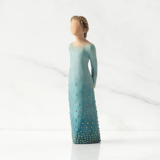 Willow Tree® Front/left view: Lighter-skin figure, arms clasped behind back, hair and deep blue ombré garment dotted with gold leaf