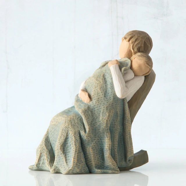 Willow Tree® Faceless woman sitting in rocking chair holding baby wrapped in large blue blanket