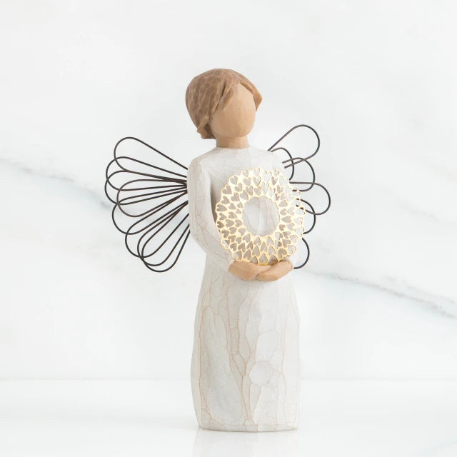 Willow Tree® Front view of angel with short, light brown hair holding a metallic wreath of hearts with both hands