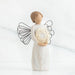 Willow Tree® Front view of angel with short, light brown hair holding a metallic wreath of hearts with both hands
