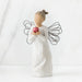 Willow Tree® Front view of angel with brown hair in high pony tail leaning forward and holding a red apple up to her face with both hands