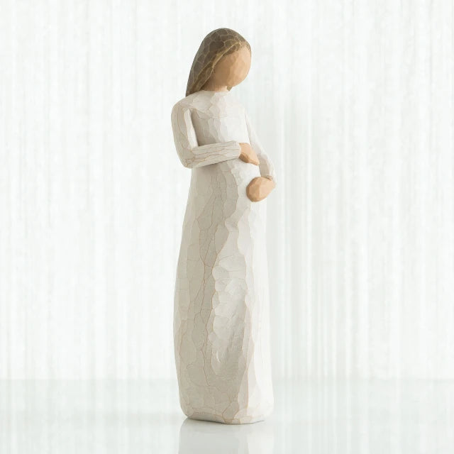Willow Tree® Faceless pregnant woman figurine wearing white dress with hands clutching her stomach