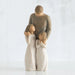 Willow Tree® Man faceless figurine wearing brown shirt standing over two faceless girl figurines in white dresses