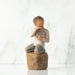 Willow Tree® Front view: Figure of lighter-skin child, kneeling on rock, holding wire circle with ‘love you’ written in wire