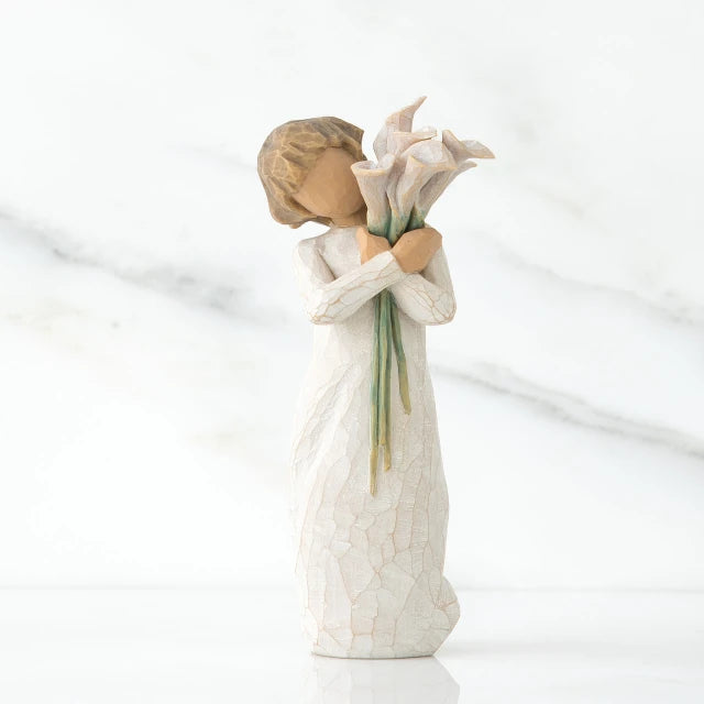 Willow Tree® Front view of lIttle girl with short brown hair holding a cluter of white calla lilies