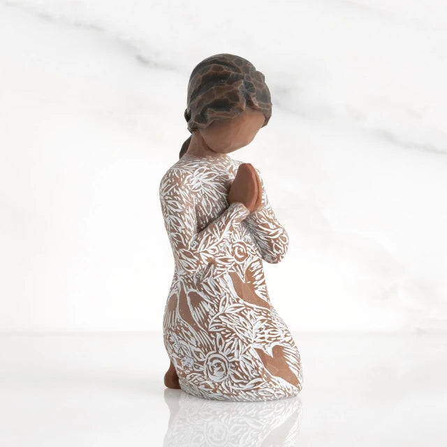 Willow Tree® Front: Kneeling figure with darker skin, hands in position of prayer or meditation in cream dress carved with icons of nature