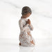 Willow Tree® Front: Kneeling figure with darker skin, hands in position of prayer or meditation in cream dress carved with icons of nature