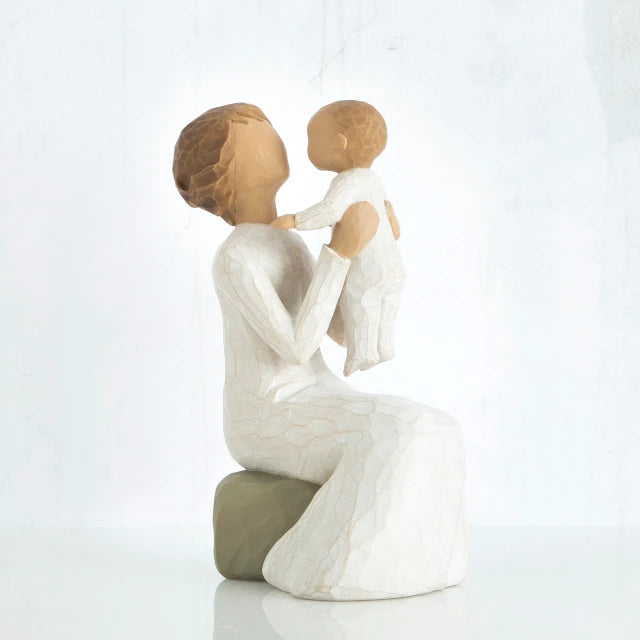 Willow Tree® Mother figurine holding baby in her lap - both faceless, wearing white