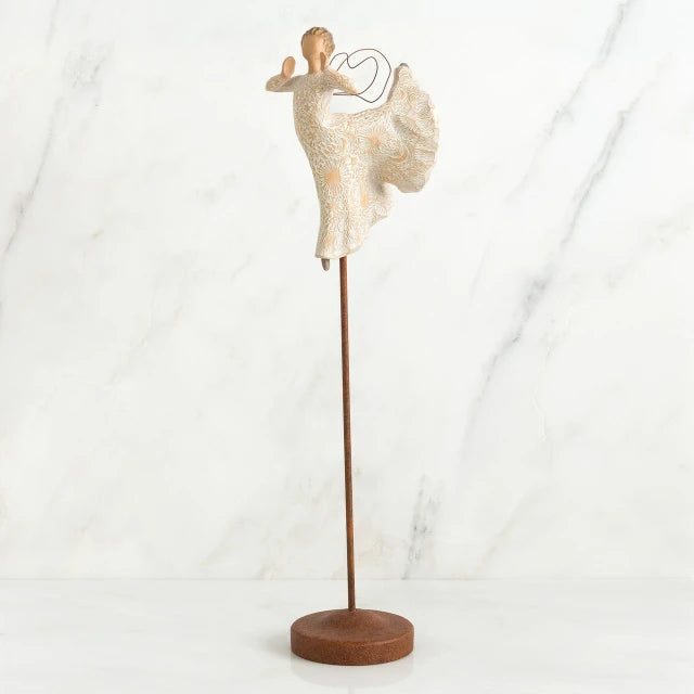 Willow Tree® Far shot of angel figurine dressed in white dress dancing with arms and legs out - she is on a brown wooden stand