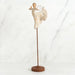 Willow Tree® Far shot of angel figurine dressed in white dress dancing with arms and legs out - she is on a brown wooden stand