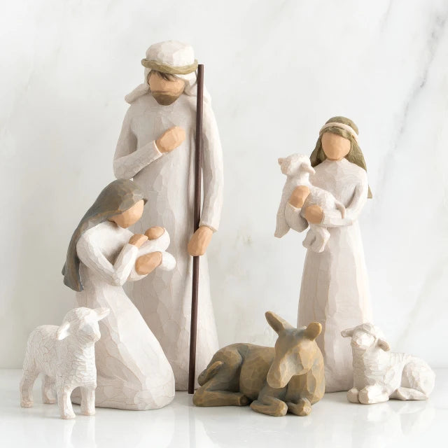 Willow Tree® Set of two faceless woman figurines and one man figurine surrounded by laying donkey and three white sheep figurines
